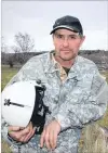  ?? PHOTO: JONO EDWARDS ?? Memento . . . Alexandra man Robert Andrews holds the helmet of his pilot brother who died in a helicopter crash in 2013.