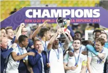  ??  ?? England players celebrate with the trophy after defeating Venezuela during the final match of the FIFA U-20 World Cup Korea 2017 at Suwon World Cup Stadium in Suwon, South Korea, on Sunday. (AP)