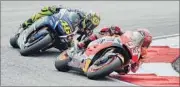  ??  ?? Valentino Rossi (in green) and Marc Marquez were engaged in a ferocious battle for third place in the opening laps in Malaysia.
AFP