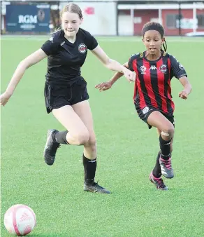  ?? ?? Running with a sole focus on the ball are Taleah Webb and Almasi Keary during Sunday soccer action.