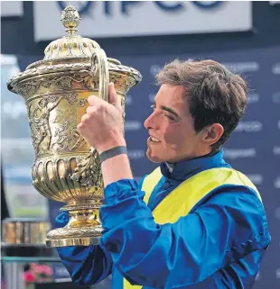  ?? Picture: PA. ?? James Doyle with the trophy after his win on Poet’s Word in the King George VI And Queen Elizabeth Stakes.