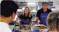  ?? SUN-SENTINEL ?? Volunteers serve lunch at the Senator Philip D. Lewis Center, Palm Beach County's first homeless resource center and shelter.