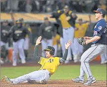  ?? JOSE CARLOS FAJARDO — STAFF PHOTOGRAPH­ER ?? The A’s Stephen Piscotty scores on a wild pitch in the ninth inning to clinch Oakland’s second walk-off win in two nights at the Coliseum.