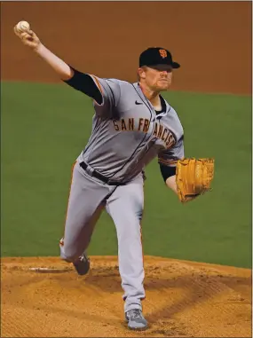  ?? JOSE CARLOS FAJARDO — STAFF PHOTOGRAPH­ER ?? Giants starter Logan Webb delivers a pitch against the Athletics in the first inning of their game Friday night at the Coliseum in Oakland.