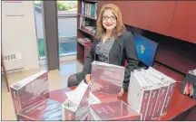  ?? SUBMITTED PHOTO ?? Gulrose Jiwani, UPEI’s dean of nursing, is surrounded by numerous self-study reports prepared for the accreditat­ion process.