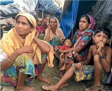  ?? JIMMY GRIFFITH ?? Rohingya families at a refugee camp in Bangladesh after fleeing attacks by Myanmar’s military. Many of Aung San Suu Kyi’s former admirers now see her as an apologist for war crimes against Myanmar’s Rohingya minority.