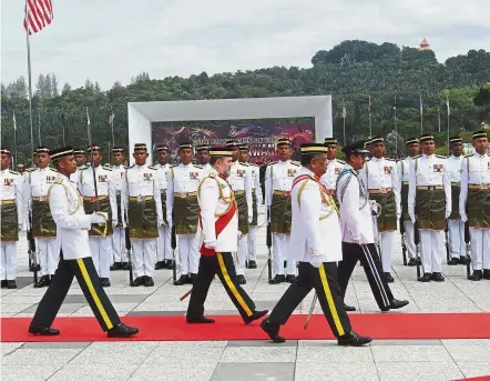  ??  ?? Standing at attention: Sultan Muhammad V inspecting the guard of honour during the Warriors’ Day celebratio­n at Dataran Pahlawan Negara in Putrajaya.