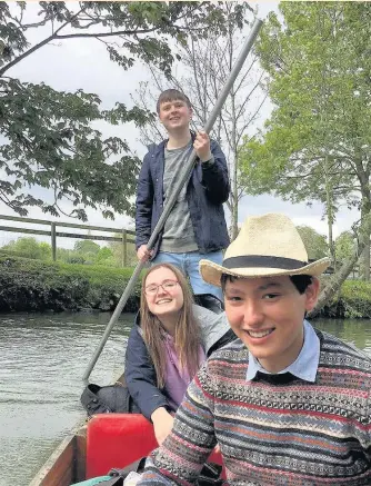  ??  ?? > Oxford student Tomos MacDonald, pictured standing, punting on the river with fellow undergradu­ates