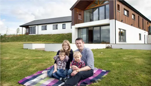  ??  ?? David and Christine with their two boys Eoghan, (four) and Ben, (16 months), outside their home in the Wexford countrysid­e. The house, designed by architect Fergus Flanagan, is single storey to the front, while the two-storey back has massive amounts...