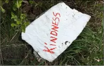  ??  ?? Above: Stones painted with messages have popped up in the woods; right: a fairy door and pom-pom.