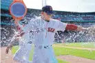  ?? ELISE AMENDOLA/ASSOCIATED PRESS ?? Mookie Betts is doused after he hit three home runs in Boston’s win Wednesday over Kansas City.