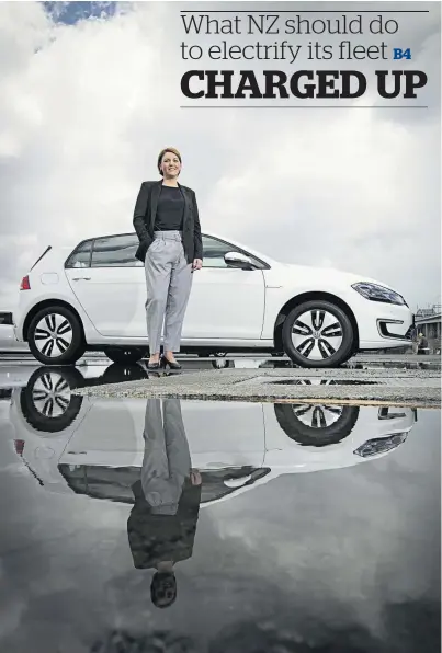  ?? Photo / Greg Bowker ?? Christina Bu, of the Norwegian Electric Vehicle Associatio­n, with an electric VW Golf in Auckland. Bu is talking to industry, automotive and Government representa­tives about Norway’s EV revolution.