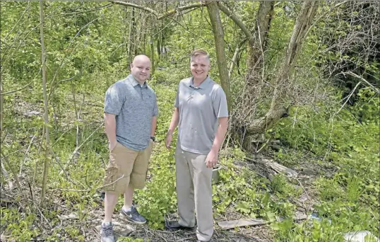  ?? Pam Panchak/Post-Gazette ?? Mark Mikesell, left, of Monroevill­e with real estate investor Aaron Chaney at the vacant lot on Saginaw Street in Esplen that Mr. Mikesell inherited then sold to Mr. Chaney. The land came with more than $50,000 in back taxes.