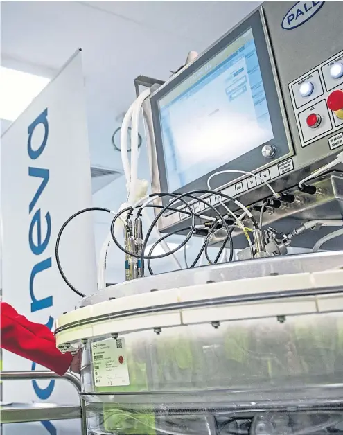  ?? Picture Andy Buchanan ?? Nicola Sturgeon operates a cell expansion bioreactor during a visit to the Valneva plant in Livingston in March