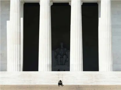  ??  ?? A man sits alone on the steps of the Lincoln Memorial in Washington DC on Monday. Photograph: Kevin Lamarque/Reuters