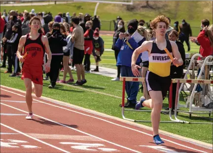  ?? BARRY BOOHER — FOR THE NEWS-HERALD ?? Riverside’s Aidan Leopold fends off Harvey’s J.T. Basco as the Beavers capture sprint medley April 3during the Red Raider Relays at Harvey. Riverside won the team title with 114 points.