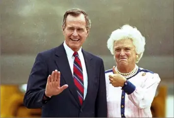  ?? Ed Reinke/Associated Press ?? Vice President George Bush waves as his wife, Barbara, gives the thumb’s up to photograph­ers on their arrival in New Orleans, Aug. 15, 1988, prior to receiving the Republican presidenti­al nomination at the Republican National Convention.