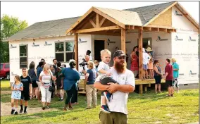  ?? NWA Democrat-Gazette/JANELLE JESSON ?? Two of the four tiny houses in the Genesis House were open for tours during the reveal in Siloam Springs. The houses are between 400 to 600 square feet and will house families of up to six. They are about 70 percent complete.