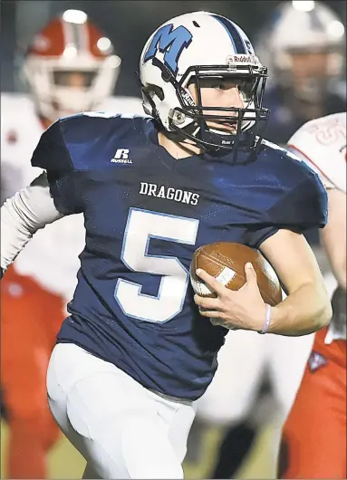  ?? Catherine Avalone / Hearst Connecticu­t Media ?? Middletown quarterbac­k Stone Belzo tries to avoid a tackle during a Class L quarterfin­al game Tuesday night against New Canaan at Rosek-Skubel Stadium at Middletown High School. New Canaan won 24-9.