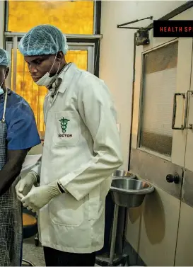  ??  ?? THE NEXT EPIDEMIC Cervical cancer specialist Michael Odutola, right, consults with Benjamin Howe Nongo, a gynecologi­st at the University of Abuja Teaching Hospital. Cancer rates are spiking across Africa, bringing a host of new health care concerns.