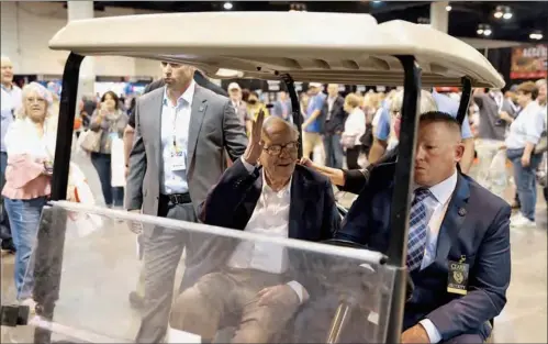  ?? ?? Berkshire Hathaway CEO Warren Buffett rides on a golf cart through the exhibition hall as investors and guests arrive for the first in-person annual meeting since 2019 of Berkshire Hathaway Inc in Omaha, Nebraska.