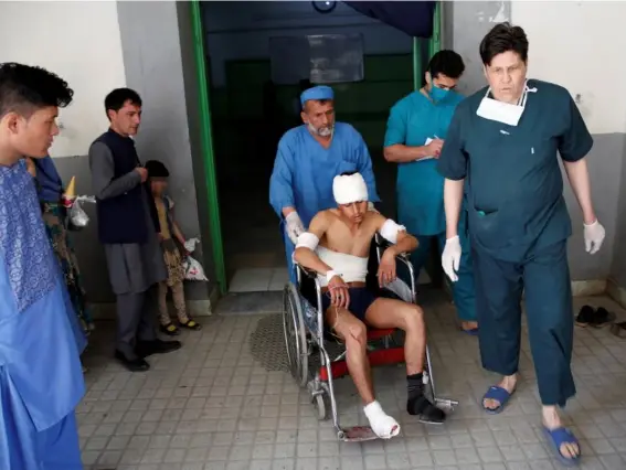  ??  ?? An injured man is wheeled into hospital after yesterday’s Afghan blast (Reuters)