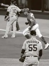  ?? Tony Gutierrez / Associated Press ?? The Astros’ Ryan Pressly watches Ronald Guzman round the bases after hitting a game-tying homer.