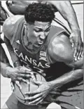  ?? ORLIN WAGNER/AP ?? David McCormack maintains possession during Kansas’ win over Kansas State.