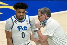  ??  ?? In the absence of Jeff Capel, Pitt associate head coach Tim O’Toole talks with Ithiel Horton during a break in play.