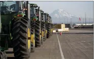  ?? ASSOCIATED PRESS FILE PHOTO ?? John Deere tractors made by Deere & Company are shown as they are readied for export to Asia at the Port of Tacoma in Tacoma, Wash.