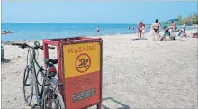  ?? BOB TYMCZYSZYN TORSTAR ?? Many beaches in Niagara, such as Sunset Beach in St. Catharines, shown, have warning signs that the water is not suitable for swimming.