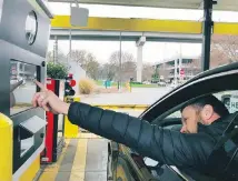  ??  ?? A rental-car driver demonstrat­es a new biometric scanning machine by placing his finger on the reader at the Hertz facility at Hartsfield-Jackson Atlanta Internatio­nal Airport.