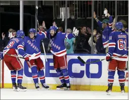  ?? ADAM HUNGER — THE ASSOCIATED PRESS ?? Rangers center Mika Zibanejad (93) celebrates with teammates after scoring a goal against the Penguins during the third period in Game 7on Sunday in New York.