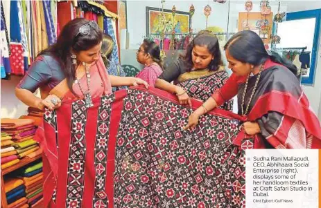  ?? Clint Egbert/Gulf News ?? Sudha Rani Mallapudi, CEO, Abhihaara Social Enterprise (right), displays some of her handloom textiles at Craft Safari Studio in Dubai.