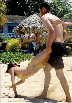  ??  ?? Playful: Meghan and a friend messing about on the Jamaican beach