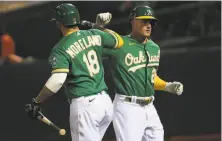  ?? Jed Jacobsohn / Associated Press ?? The A’s Matt Chapman (right) is greeted by Mitch Moreland after hitting a solo homer in the eighth inning.