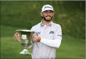  ?? NICK WASS — THE ASSOCIATED PRESS ?? Max Homa holds the trophy after winning the Wells Fargo Championsh­ip golf tournament, Sunday at TPC Potomac at Avenel Farm golf club in Potomac, Md.