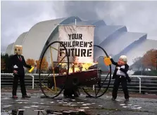  ?? ?? Ocean Rebellion’s giant head of Boris Johnson setting fire to an installati­on entitled Your Children’s Future
