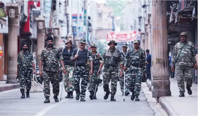  ?? Agence France-presse ?? ↑ Security personnel patrol along a street in Jammu on Tuesday.