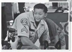  ?? Dan Watson/The Signal ?? (Left) Ethan Han, 8, places his face in a cutout for a photo at the Los Angeles County Sheriff’s Department’s booth. Those in attendance also said they were able to do a meetand-greet with a number of deputies and cadets who serve the local community.