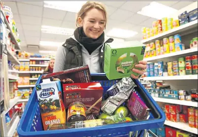  ??  ?? FOOD FOR THOUGHT: Shopper Ffion Heledd at her local Scotmid Co-op store in Stockbridg­e, Edinburgh. The firm has boosted profits by £1m.