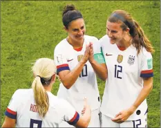  ?? Thibault Camus / Associated Press ?? The United States’ Carli Lloyd, center, celebrates with Lindsey Horan and Tierna Davidson, right, after scoring the opening goal during the Women’s World Cup Group F soccer match against Chile on Sunday at the Parc des Princes in Paris.