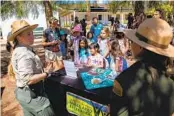  ?? ADRIANA HELDIZ U-T ?? Senior Park Ranger Allison Lee explains backpackin­g to a group of girls with Outpost Summer Camp at Los Peñasquito­s Canyon County Preserve.