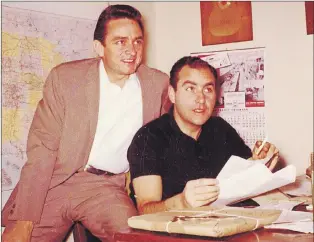  ?? SAUL HOLIFF COLLECTION VIA CP ?? Johnny Cash and Saul Holiff at the Johnny Cash Incorporat­ed office in Ventura, Calif., in the fall of 1961, in this handout photo. In her new book “The Man Who Carried Cash,” Julie Chadwick explores the complex personal and business relationsh­ip between Johnny Cash and Saul Holiff, his London, Ont.-born manager.