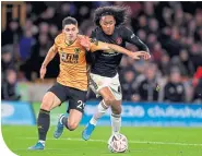  ??  ?? Ruben Vinagre holds off United’s Tahith Chong