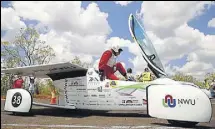  ?? AFP ?? The driver of NWU solar vehicle "Naledi" from South Africa gets out of the car at a control stop on the first day of the World Solar Challenge race.