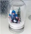  ?? THE ASSOCIATED PRESS ?? A handmade snow globe, though this version doesn’t include water. It features a photo, decorative tree and kosher salt serving as “snow.”