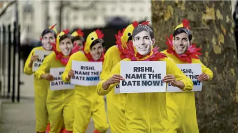  ?? ?? PRESSURE: Demonstrat­ors dressed as chickens protest opposite Downing Street as Labour call for an election.