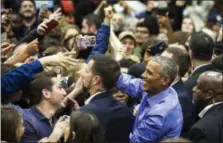  ?? ASHLEE REZIN/CHICAGO SUN-TIMES VIA AP ?? Former President Barack Obama greets people Sunday at a rally for Illinois Democrats at the University of Illinois at Chicago, in Chicago.