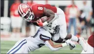  ?? Darron Cummings / Associated Press ?? Indiana running back Stevie Scott III (8) is tackled by UConn linebacker Omar Fortt (27) during a 2019 game.